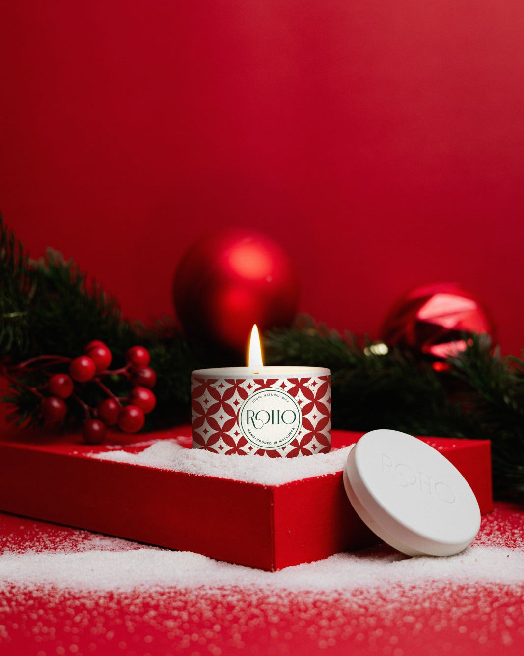 Scented Candle with a red box and Christmas decorations on a red background. Gift Idea