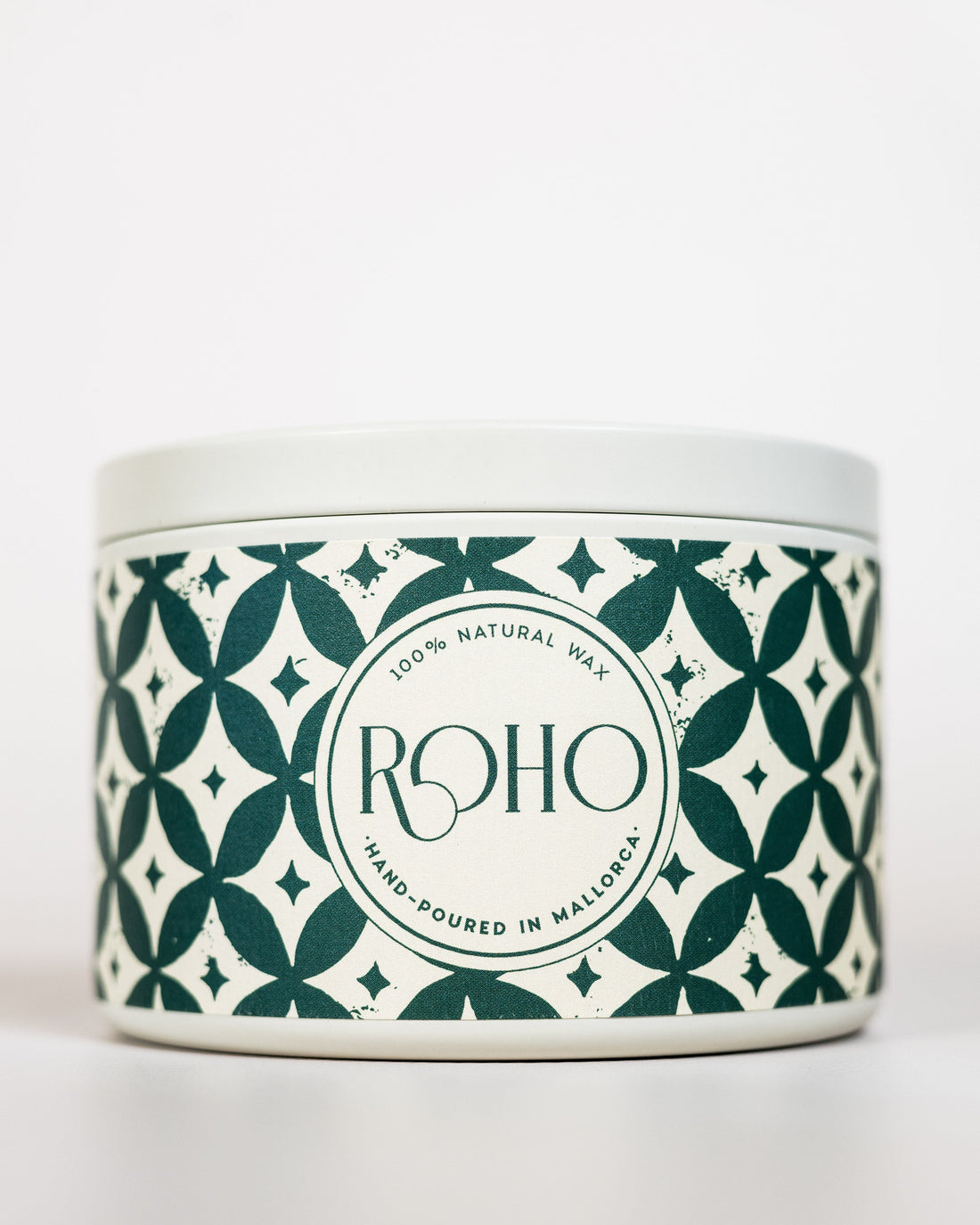 Scented Candle with a decorative patterned label on a green background. Winter Candle, Orange and Cinnamon scent, Winter Candle