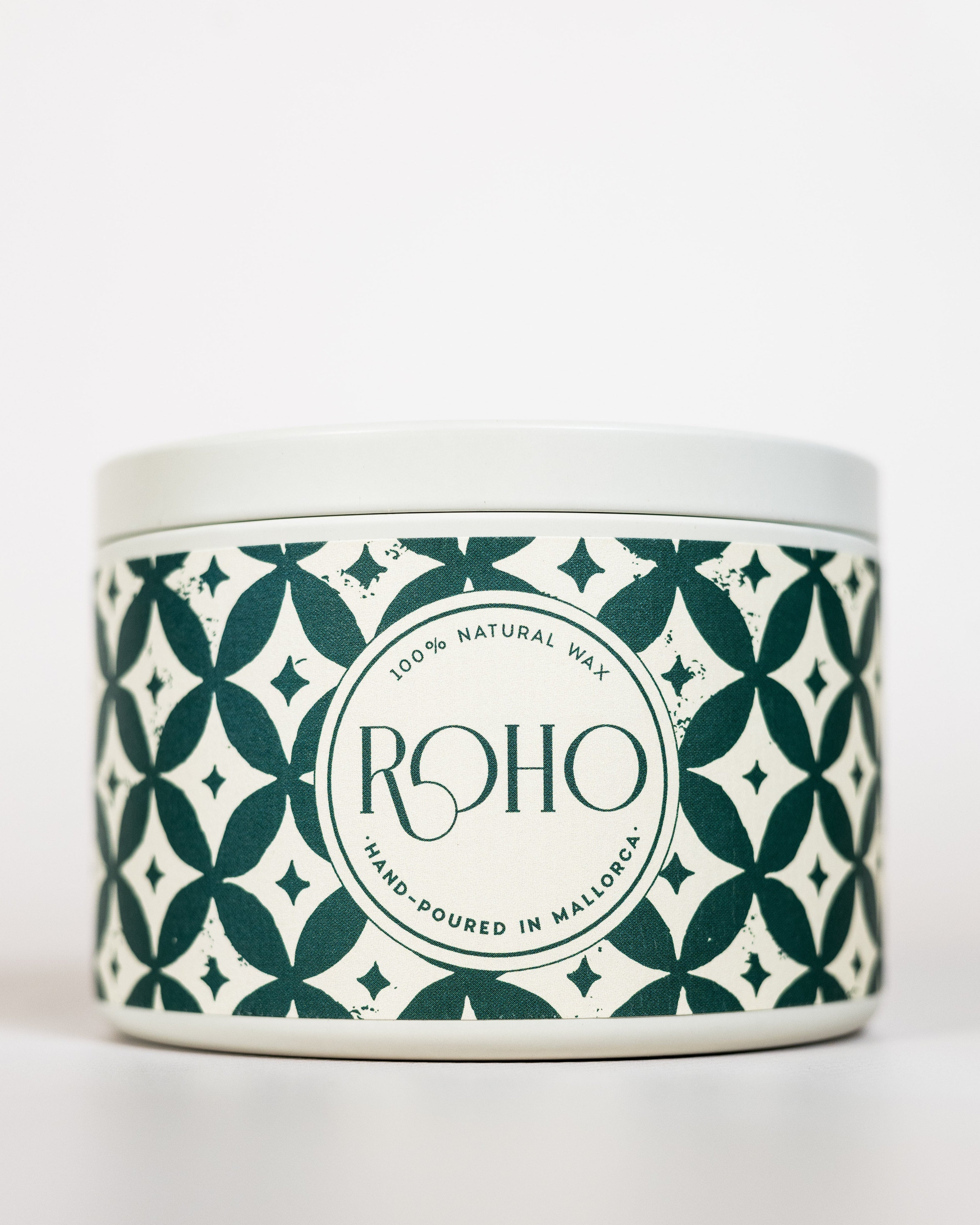 Scented Candle with a decorative patterned label on a green background. Winter Candle, Orange and Cinnamon scent, Winter Candle