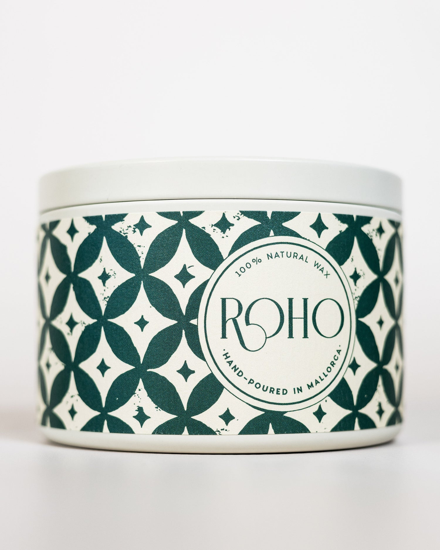 Scented Candle with a decorative patterned green label on a white background. Winter Candle, Orange and Rosemary scent